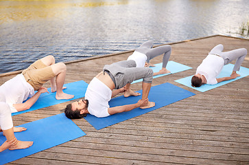 Image showing group of people making yoga exercises outdoors