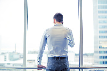 Image showing businessman calling on smartphone in office