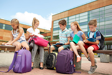 Image showing group of happy elementary school students outdoors