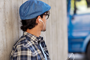 Image showing man with earphones and smartphone listening music