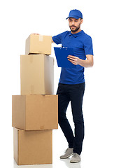 Image showing delivery man with parcel boxes and clipboard