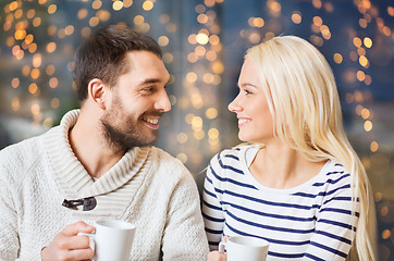 Image showing happy couple drinking tea or coffee at cafe