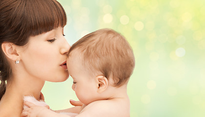 Image showing happy mother kissing adorable baby