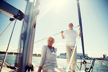 Image showing senior couple hugging on sail boat or yacht in sea