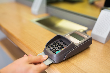 Image showing close up of hand inserting bank card to terminal