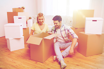 Image showing smiling couple with big boxes moving to new home