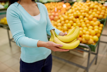 Image showing woman with bananas at grocery store