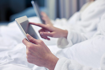 Image showing close up of woman hands in bathrobe with tablet pc