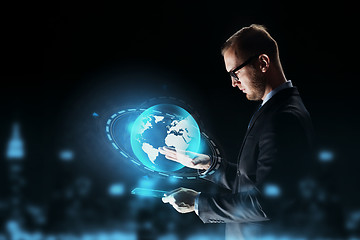 Image showing businessman with tablet pc and earth hologram