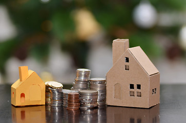 Image showing Paper house and stacks of coins standing