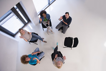 Image showing Multiethnic startup business team on meeting  top view