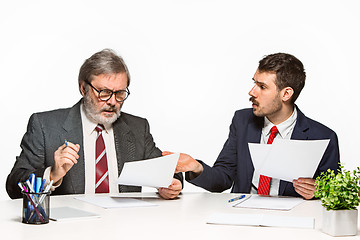 Image showing The two colleagues working together at office on white background.