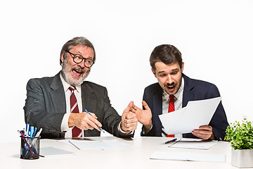 Image showing The two colleagues working together at office on white background.