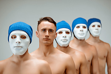 Image showing The people in masks and one man without mask