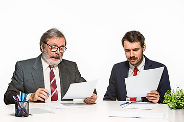 Image showing The two colleagues working together at office on white background.