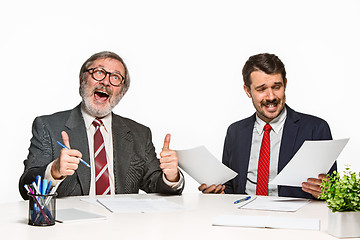 Image showing The two colleagues working together at office on white background.