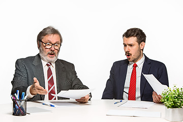 Image showing The two colleagues working together at office on white background.