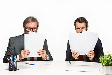 Image showing The two colleagues working together at office on white background.