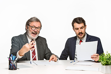 Image showing The two colleagues working together at office on white background.