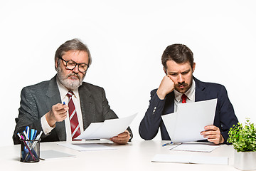 Image showing The two colleagues working together at office on white background.