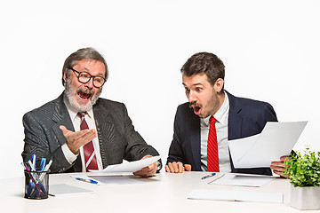 Image showing The two colleagues working together at office on white background.