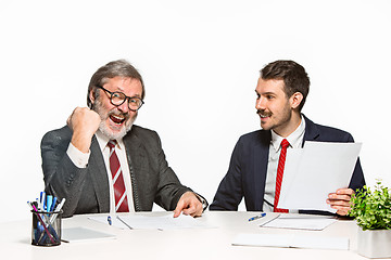 Image showing The two colleagues working together at office on white background.