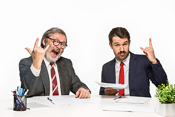 Image showing The two colleagues working together at office on white background.