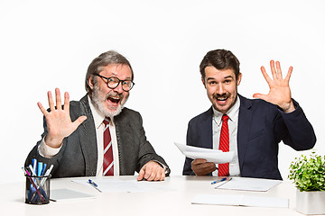 Image showing The two colleagues working together at office on white background.