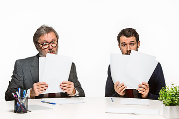 Image showing The two colleagues working together at office on white background.