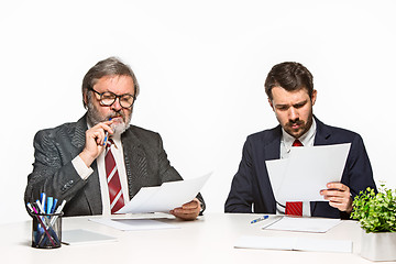 Image showing The two colleagues working together at office on white background.