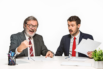 Image showing The two colleagues working together at office on white background.