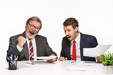 Image showing The two colleagues working together at office on white background.