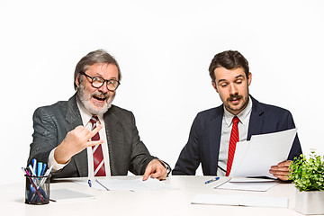 Image showing The two colleagues working together at office on white background.