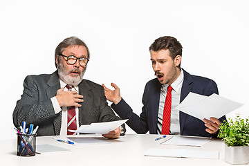 Image showing The two colleagues working together at office on white background.