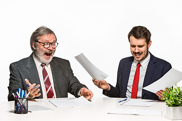 Image showing The two colleagues working together at office on white background.