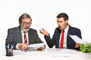 Image showing The two colleagues working together at office on white background.