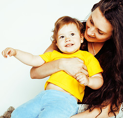 Image showing young pretty stylish mother with little cute daughter hugging, happy smiling family, lifestyle people concept 