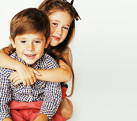 Image showing little cute boy and girl hugging playing on white background, ha