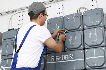 Image showing Electrician repairs dashboard.