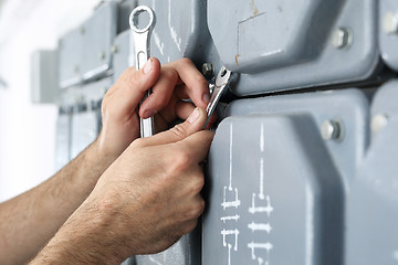 Image showing Electrician repairs installations.