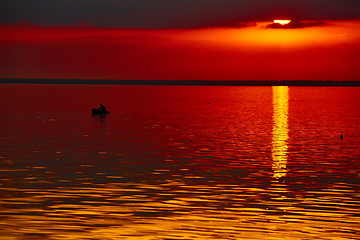 Image showing good red sunset over darken sea