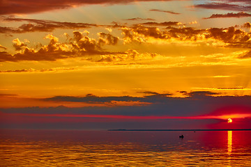 Image showing good red sunset over darken sea