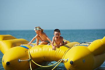 Image showing two happy kids playing on the boat at summer day