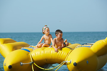Image showing two happy kids playing on the boat at summer day