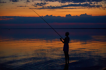 Image showing Fishing Silhouette on dramatic sky and sea