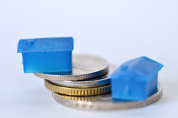 Image showing Little plastic house on metal coins