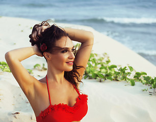 Image showing young pretty hispanic woman on seacoast with flying hair, hot se