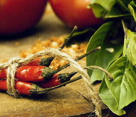 Image showing vegetables on wooden kitchen with spicies, tomato, chilli, green