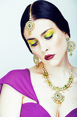 Image showing young pretty caucasian woman like indian in ethnic jewelry close up on white, bridal bright makeup