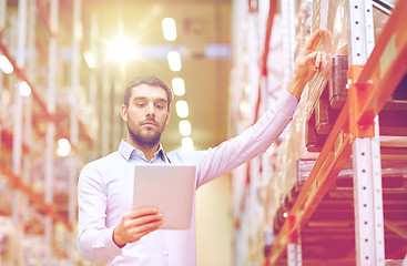 Image showing businessman with tablet pc at warehouse